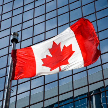 Canadian flag in front of commercial building